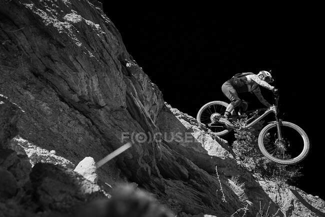Un ciclista di montagna che scende da una goccia in Colorado. — Foto stock