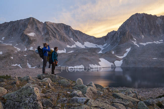 Man and woman tourists descend the Northeast Ridge of Capitol Peak, Elk Mountains, Colorado. — Stock Photo