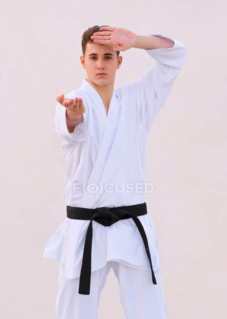 Teenager boy karate expert practicing fighting positions with hi — Stock Photo