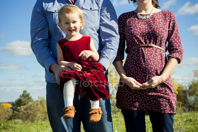 Young pregnant couple holding daughter in Detroit MI — Stock Photo