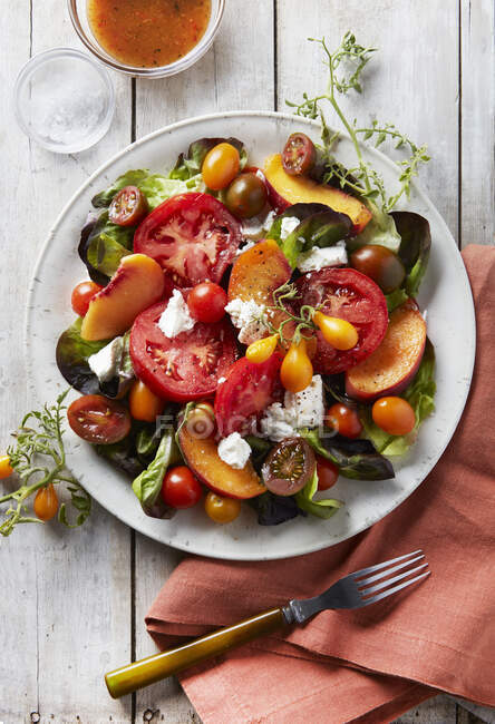 Салат з помідорами, сиром фета, помідорами, оливками та базиліком — стокове фото