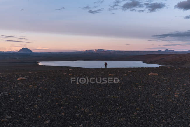 Beautiful sunset on the island and hiker on nature background — Fotografia de Stock
