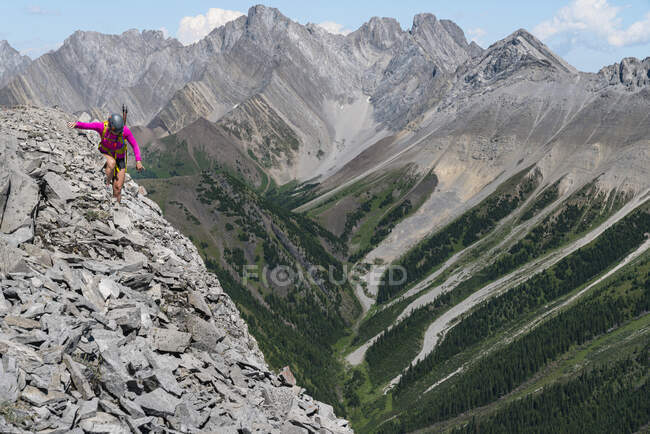 Female Hiker Scrambling Along High Ridge In Kananaskis Alberta — Stock Photo