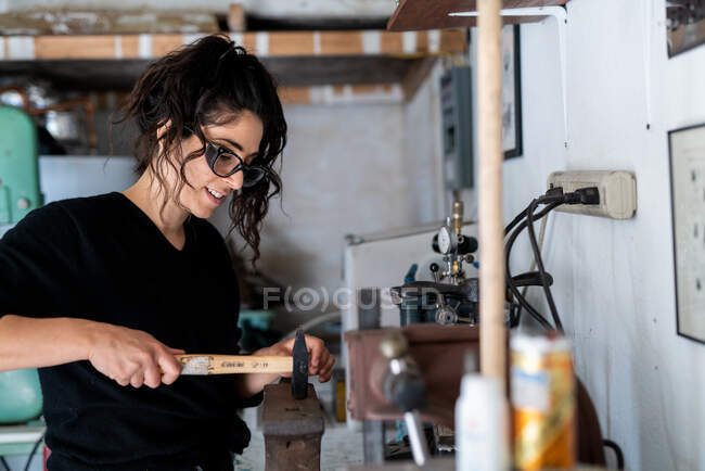 Jeune femme travaillant avec un tatouage dans l'atelier — Photo de stock