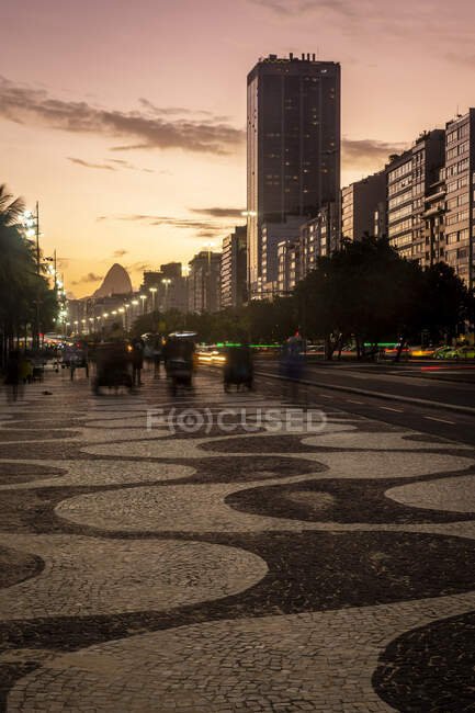 Hermosa vista al atardecer a la playa de Copacabana paseo y edificios - foto de stock