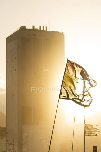 Bela vista para bandeiras e construção durante o pôr do sol na praia de Copacabana — Fotografia de Stock