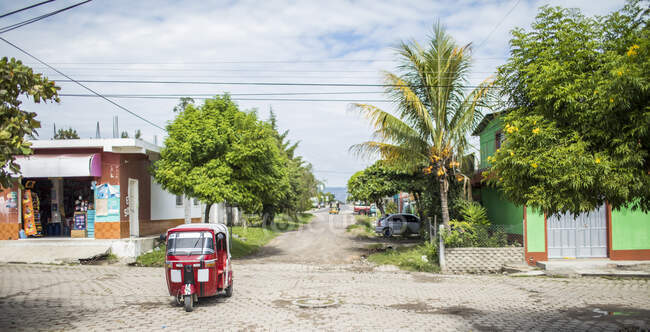 Tuk tuk driving on street en Monjas, Guatemala - foto de stock
