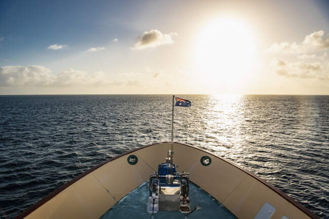 Australian exploration vessel heading into the setting sun — Stock Photo