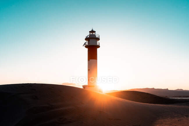 Far lighthouse water sky sunset — Stock Photo