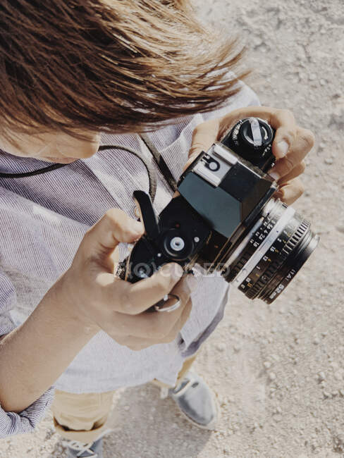Close up portrait of a kid holding a vintage camera — Stock Photo