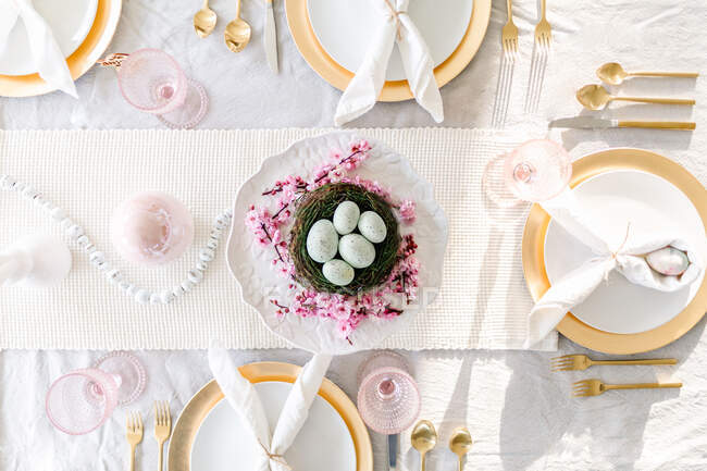 Overhead shot of easter tablescape with cherry blossoms — Stock Photo