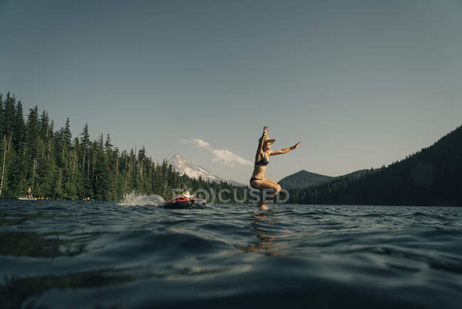 Young woman in wetsuit on the river — Stock Photo