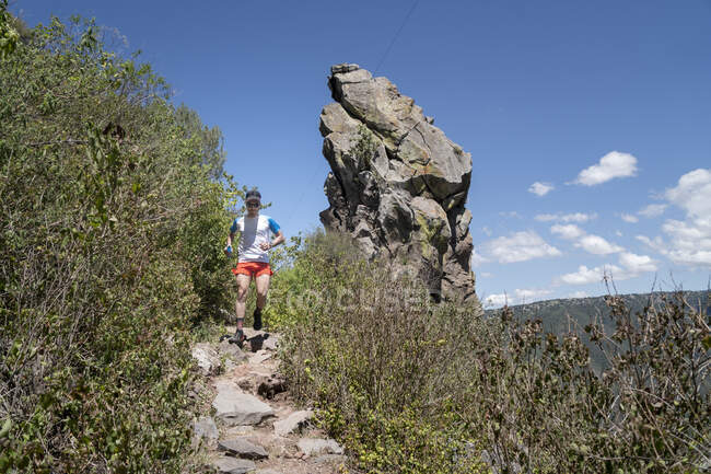 Man running on a trail descending from Pea del Aire — Stock Photo