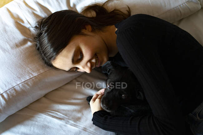 Woman sleeping with a dog. — Stock Photo