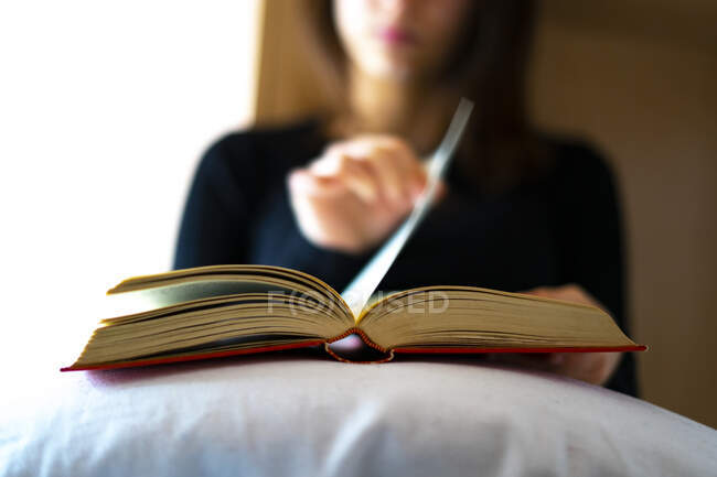 Mulher virando a página de um livro. — Fotografia de Stock