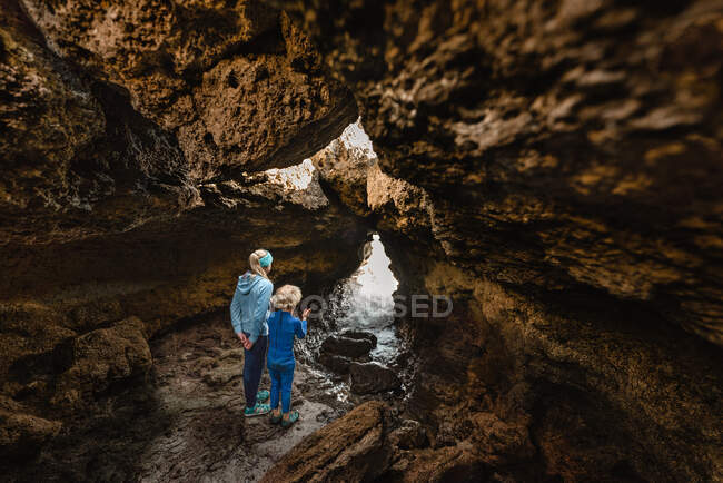 Siblings exploring sea cave in New Zealand — Stock Photo