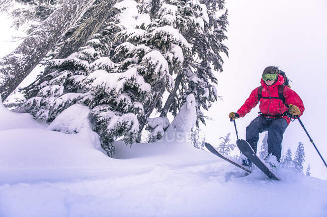 Mann springt beim Skilanglauf in BC von schneebedeckter Schanze — Stockfoto