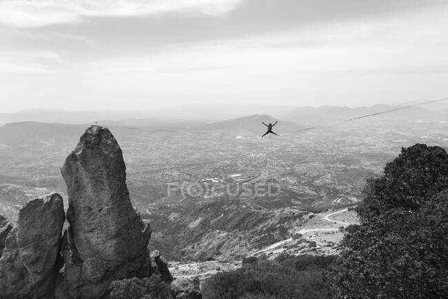 One man balances with open legs and arms in a highline at Los Frailes — Stock Photo