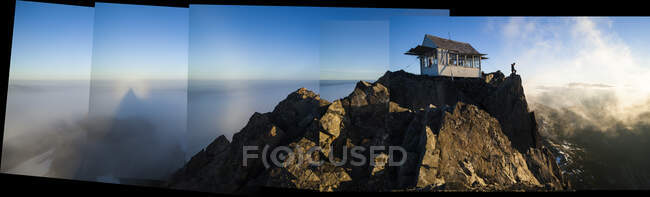 Hiker stands at sunrise outside Three Fingers Lookout, North Cascades — Stock Photo