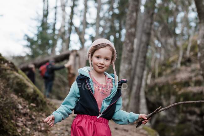 Portrait of a young girl holding a stick whilst hiking in Sweden — Stock Photo