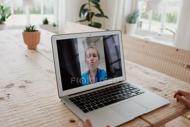 A nurse at work in a hospital having a video call with her family — Stock Photo