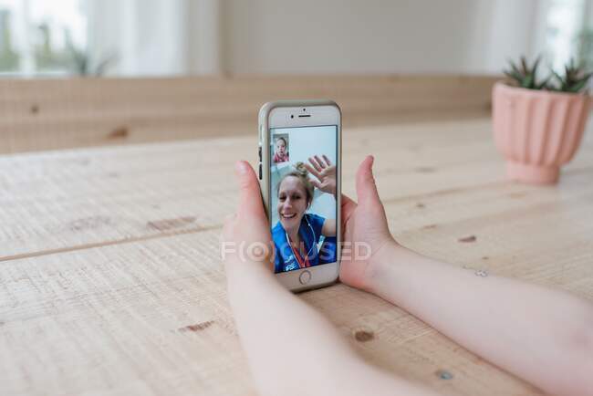 Menina ter um vídeo chamada com uma enfermeira em um hospital acenando — Fotografia de Stock
