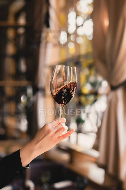 Жінка тримає келих вина і червону келих шампанського — стокове фото
