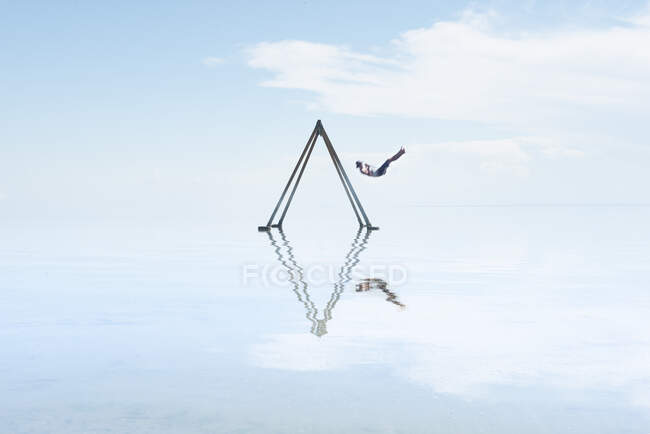 Self Portrait on Swing Set in Reflection on Salton Sea Californi — Stock Photo