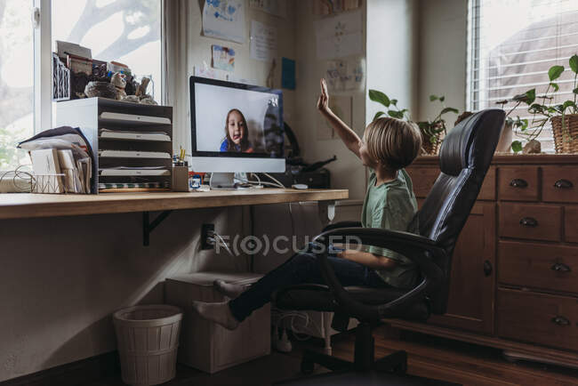 Young boy video chatting with family remotely — Stock Photo