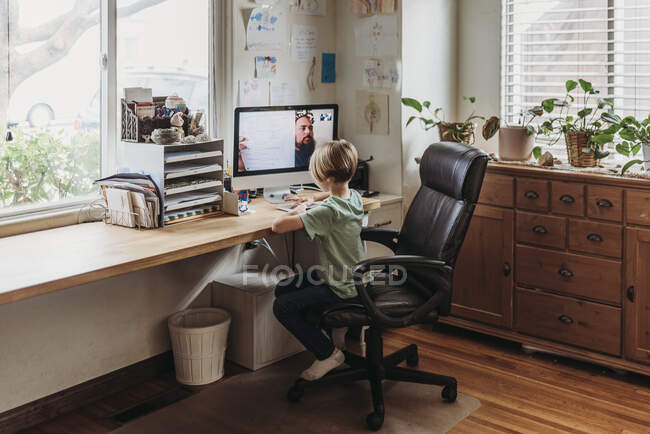 Young student learning from teacher by remote education — Stock Photo
