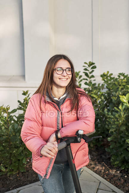 Giovane bella donna con scooter in città — Foto stock
