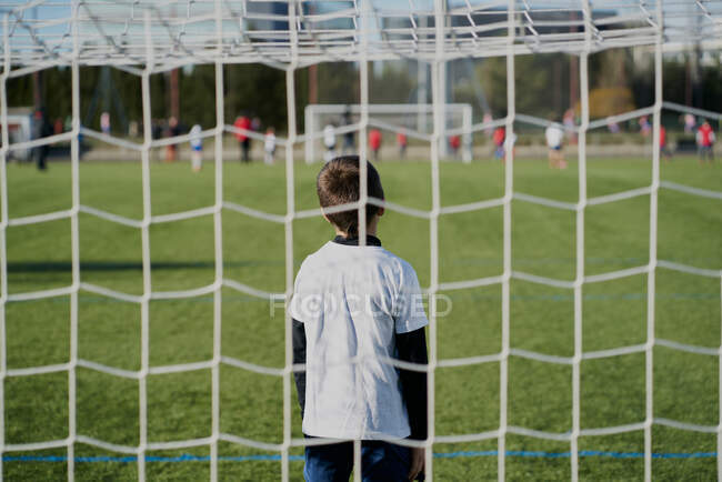 Gatekeeper children soccer player in action. stadium — Stock Photo