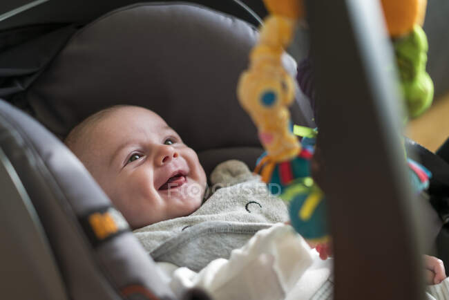 High angle view of smiling baby in car seat — Stock Photo