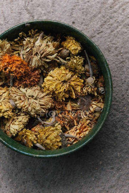 Dried herbs and spices in a wooden bowl — Stock Photo