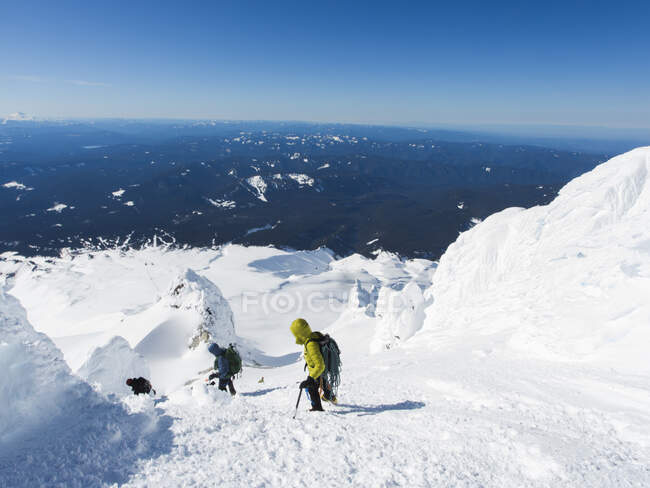 Two men climb down from the summit of Mt. Hood in Oregon. — Stock Photo