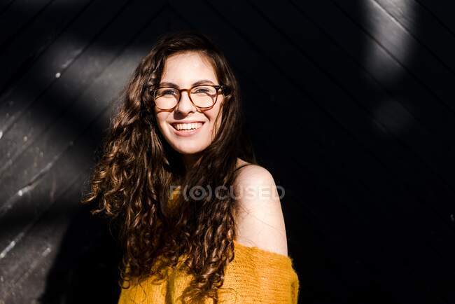 Jeune femme tenant dans une jolie lumière du soleil — Photo de stock