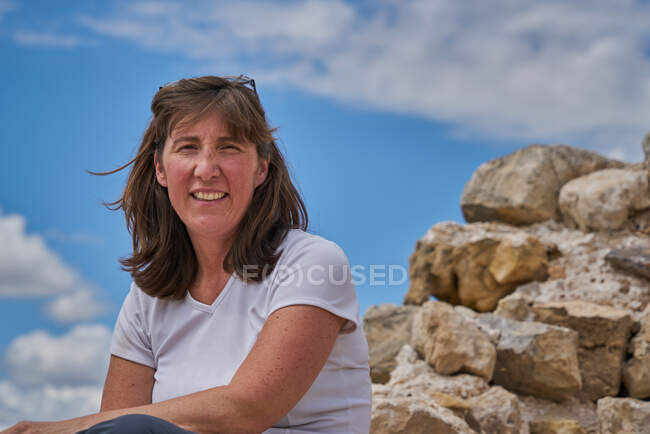 Thoughtful Woman Sitting On Rock — Stock Photo