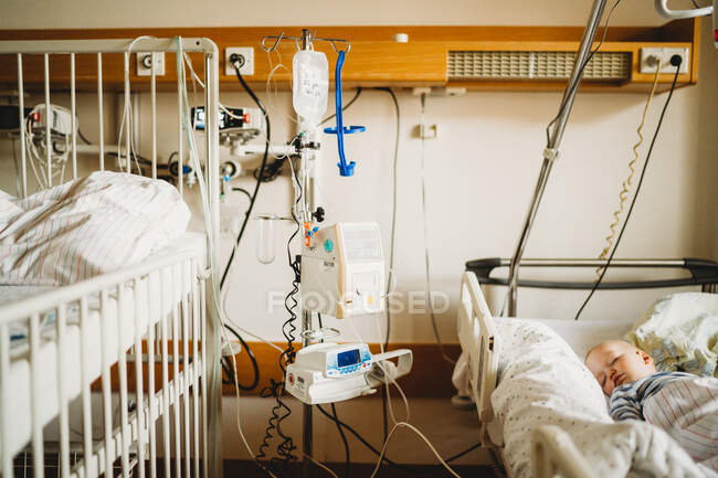 Little toddler boy on hospital bed — Stock Photo