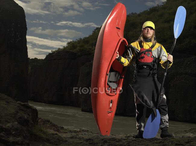 Молодий чоловік, який кидає на річку Хвіта свій білий водяний каяк. — стокове фото