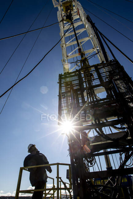 Drilling for natural gas with sun flare — Stock Photo