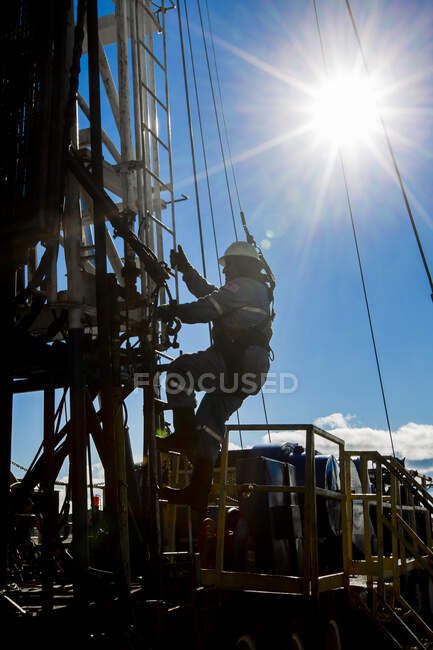 Drilling for natural gas against sun flare — Stock Photo