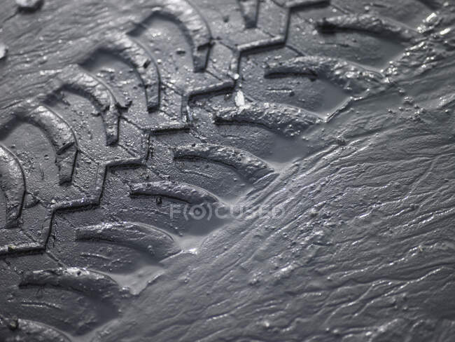 Close up of SUV tyre tracks in grey mud — Stock Photo