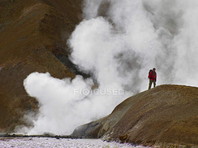 Hiker walking by geothermal vent — Stock Photo