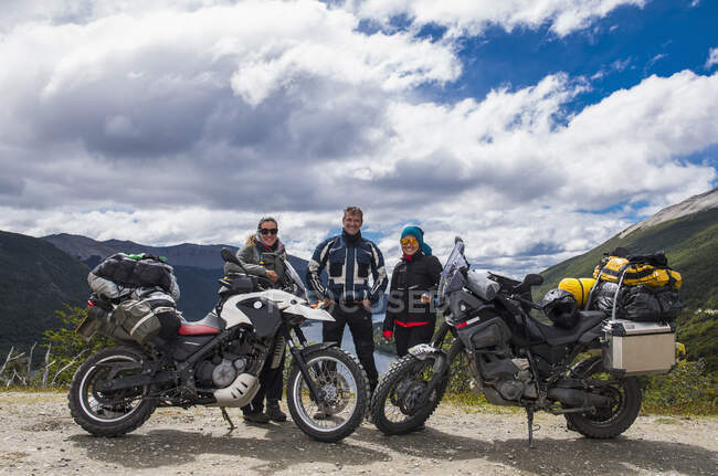 Three bikers posing behind their motorbikes in Tierra del Fuego — Stock Photo