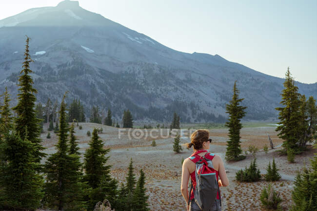 Mulher olhando para a montanha durante a caminhada no verão — Fotografia de Stock