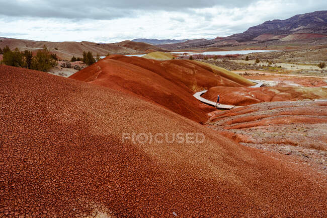 Wide view of woman walking on boardwalk at Painted Hills — Stock Photo