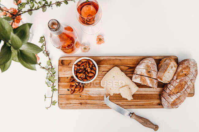 Cheese and honey on a wooden board — Stock Photo