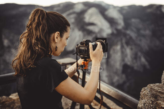 Woman photographing half dome from glacier point — Stock Photo