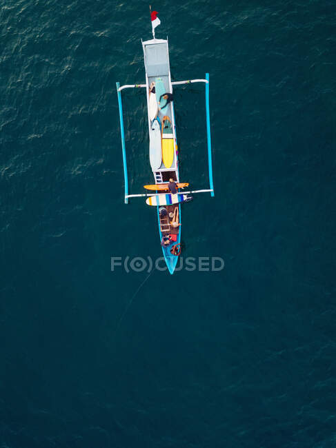 Aerial view of surfers and boat in the ocean, Lombok, Indonesia — Stock Photo