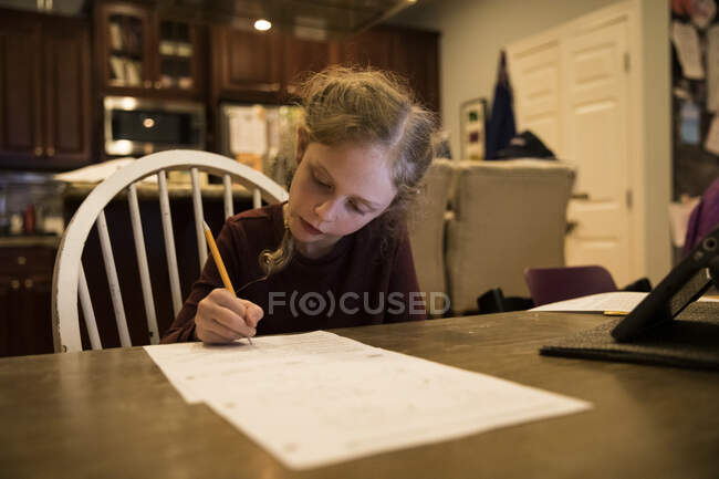 Cute Blonde Girl With French Braids Works on School Papers at Home — Stock Photo